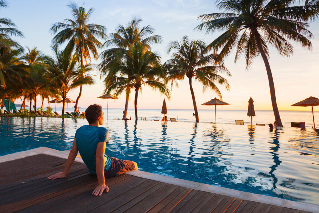 Luxury travel advisor by an infinity pool on the beach