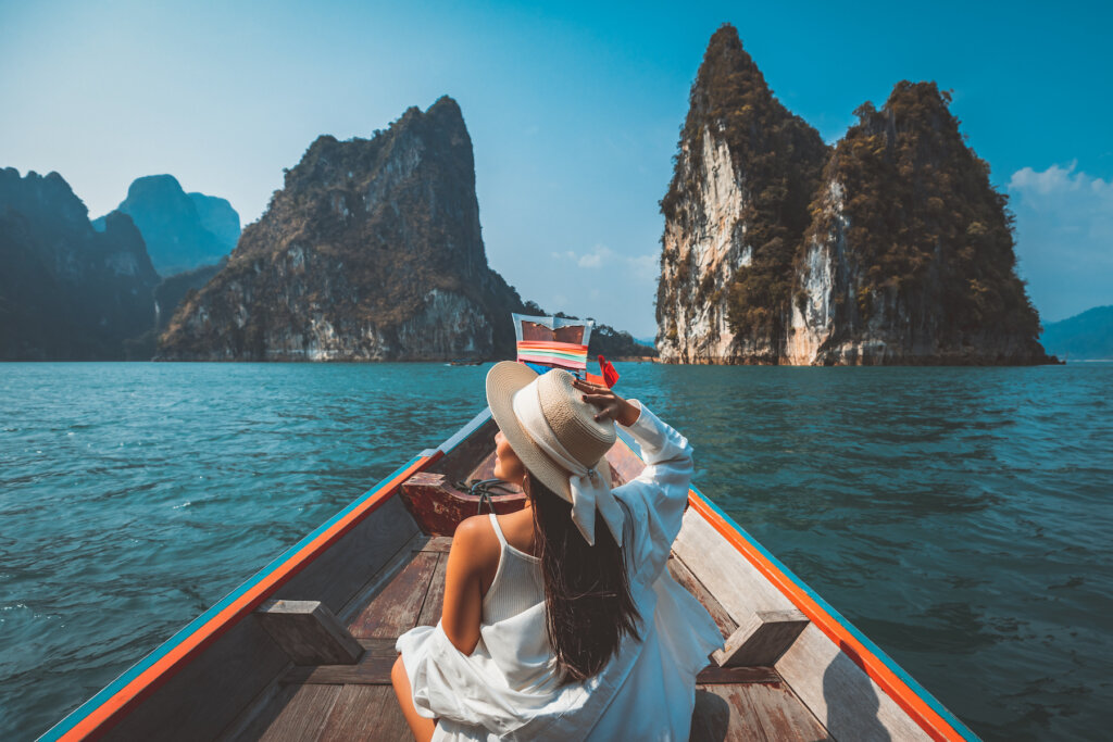 A luxury travel advisor in a boat on the ocean in Asia with beautiful rock formations and scenery